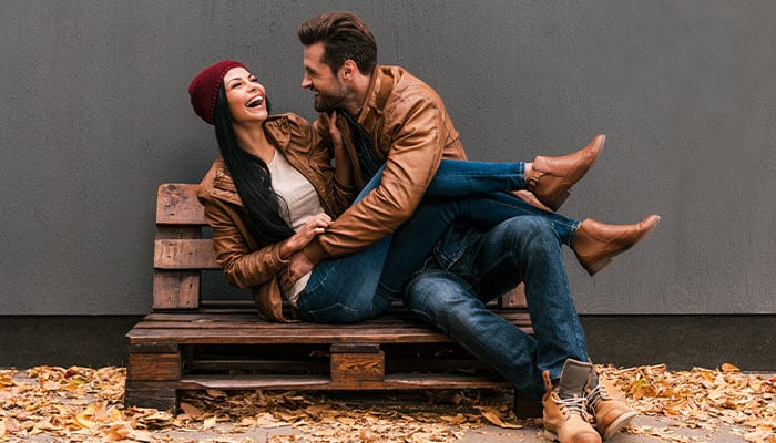 happy couple on park bench