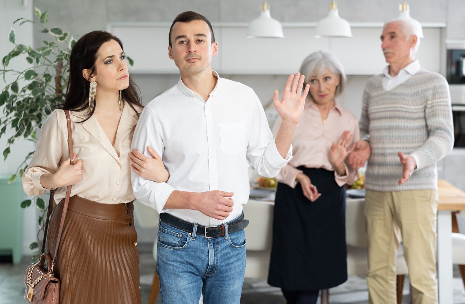 Grumpy,Elderly,Parents,Condemn,And,Look,Unkindly,After,Newlyweds.,Family Grumpy elderly parents condemn and look unkindly after newlyweds. Family conflict, pensioners send their son with girlfriend out of apartment. Dispute discord within family, condemnation and rejection
